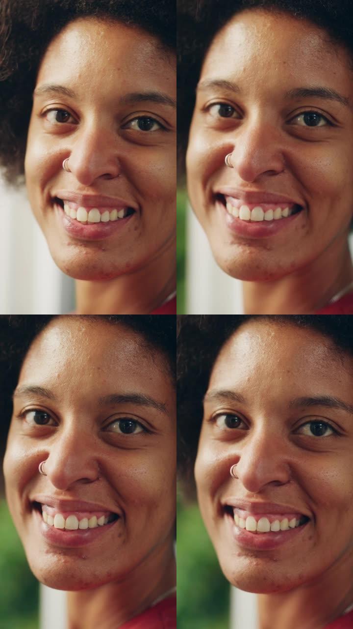 一个快乐的年轻拉丁人的垂直肖像，棕色的眼睛，非洲的头发和鼻子穿孔，为相机摆姿势。美丽多样的多种族黑人
