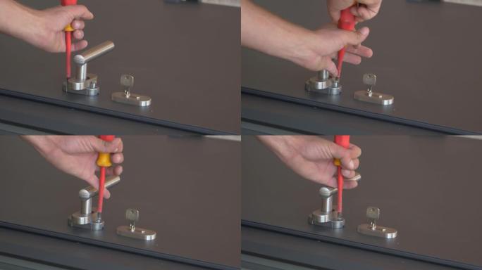 特写: 锁匠在前门安装把手时紧固螺丝。