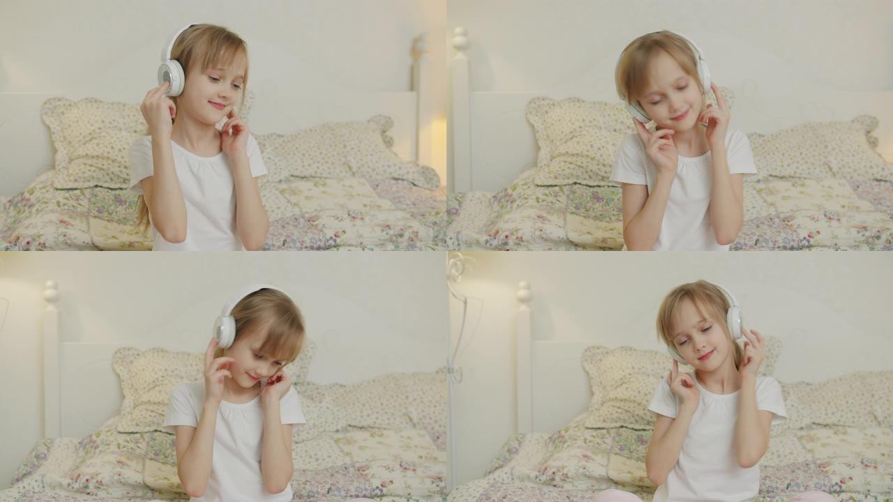 美丽的小女孩戴着耳机听音乐，独自坐在床上跳舞