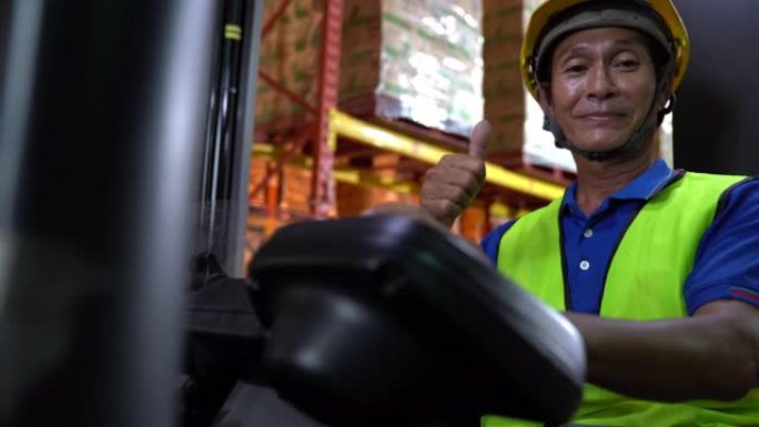 多莉拍摄肖像: 亚洲男叉车操作员微笑。仓储货物行业概念。