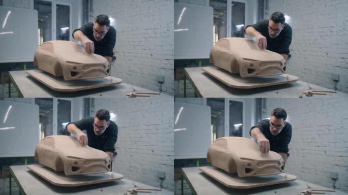 汽车设计师使用雕刻工具雕刻汽车的原型模型
