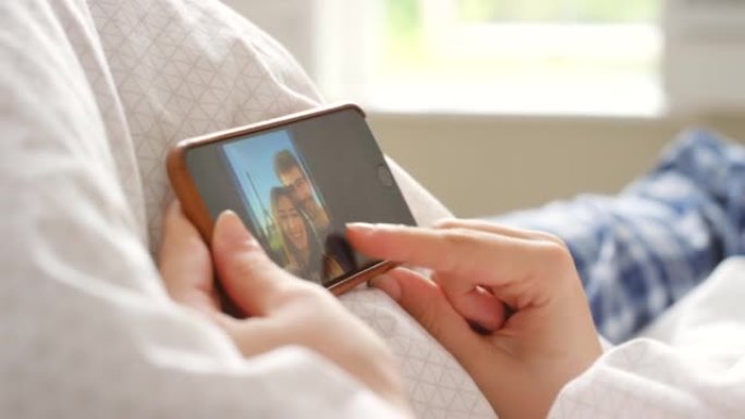 一对无法识别的夫妇使用智能手机观看照片的4k视频片段