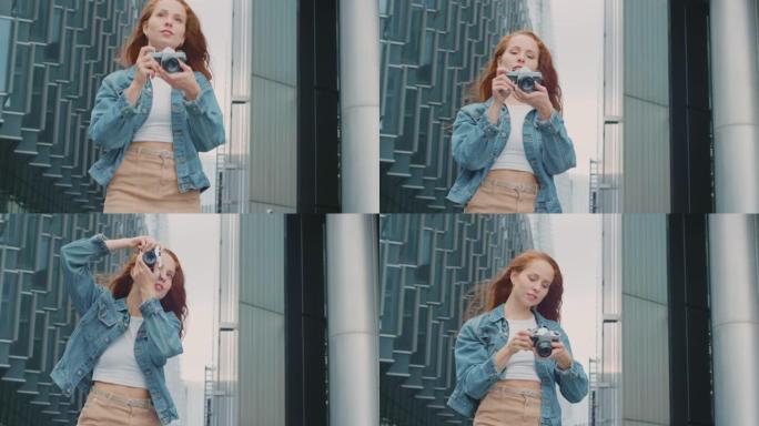城市中的年轻女子在数码相机上拍照以发布到社交媒体上