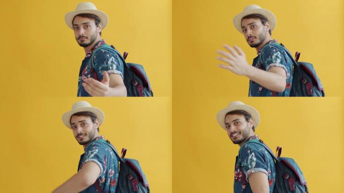 英俊的阿拉伯游客的慢动作肖像转向相机，要求跟随说话和挥手