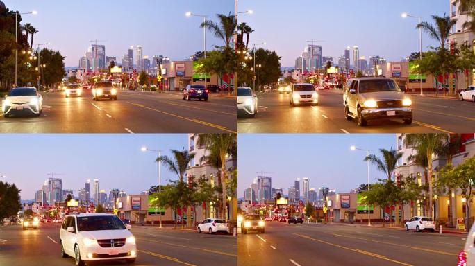 洛杉矶城市路。汽车交通。夜间照明金融区。棕榈。