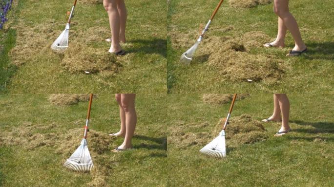 特写: 年轻女子在春季草坪曝气后耙成堆的草毡
