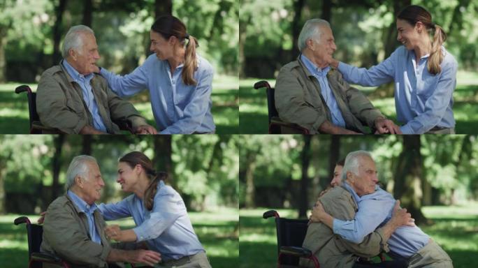 快乐孙女的电影镜头正在轮椅上给祖父一个情感上的拥抱，作为绿色公园中爱与尊重的标志。生活观念，祖父母，