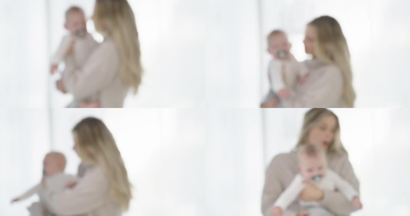 4k视频片段，一位无法辨认的母亲在家里的卧室里抱着婴儿