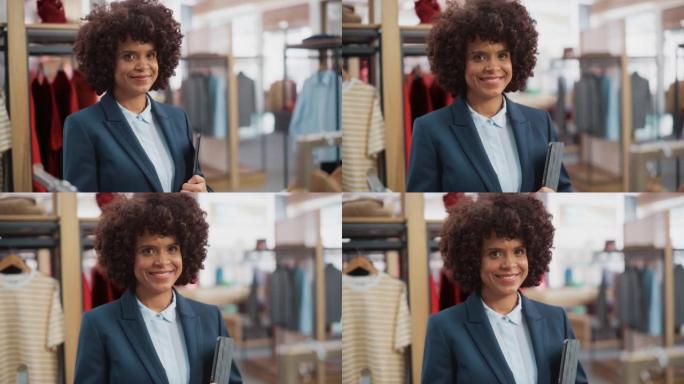 一位快乐的黑人女性肖像，时尚的非洲头发微笑着，在平板电脑的服装店摆姿势拍照。小企业主，担任女商人或销