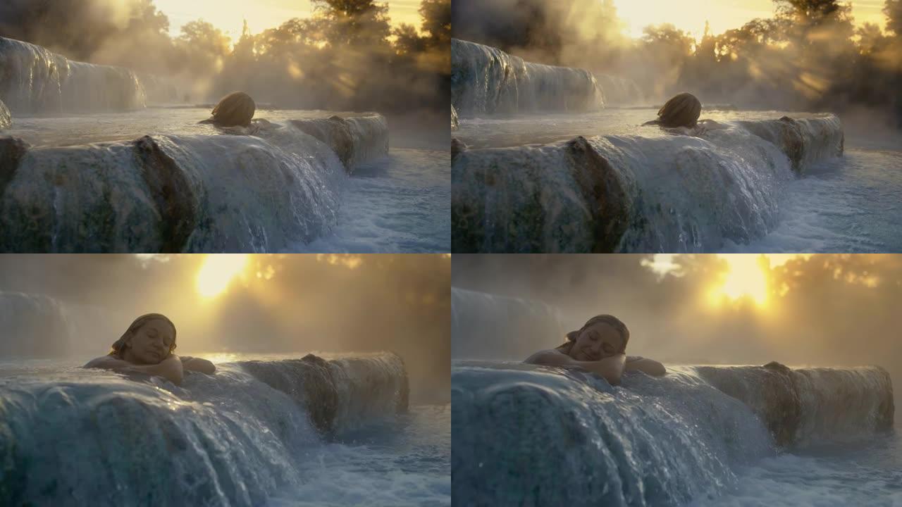 日落时分，SLO MO女人在Saturnia温泉中沐浴
