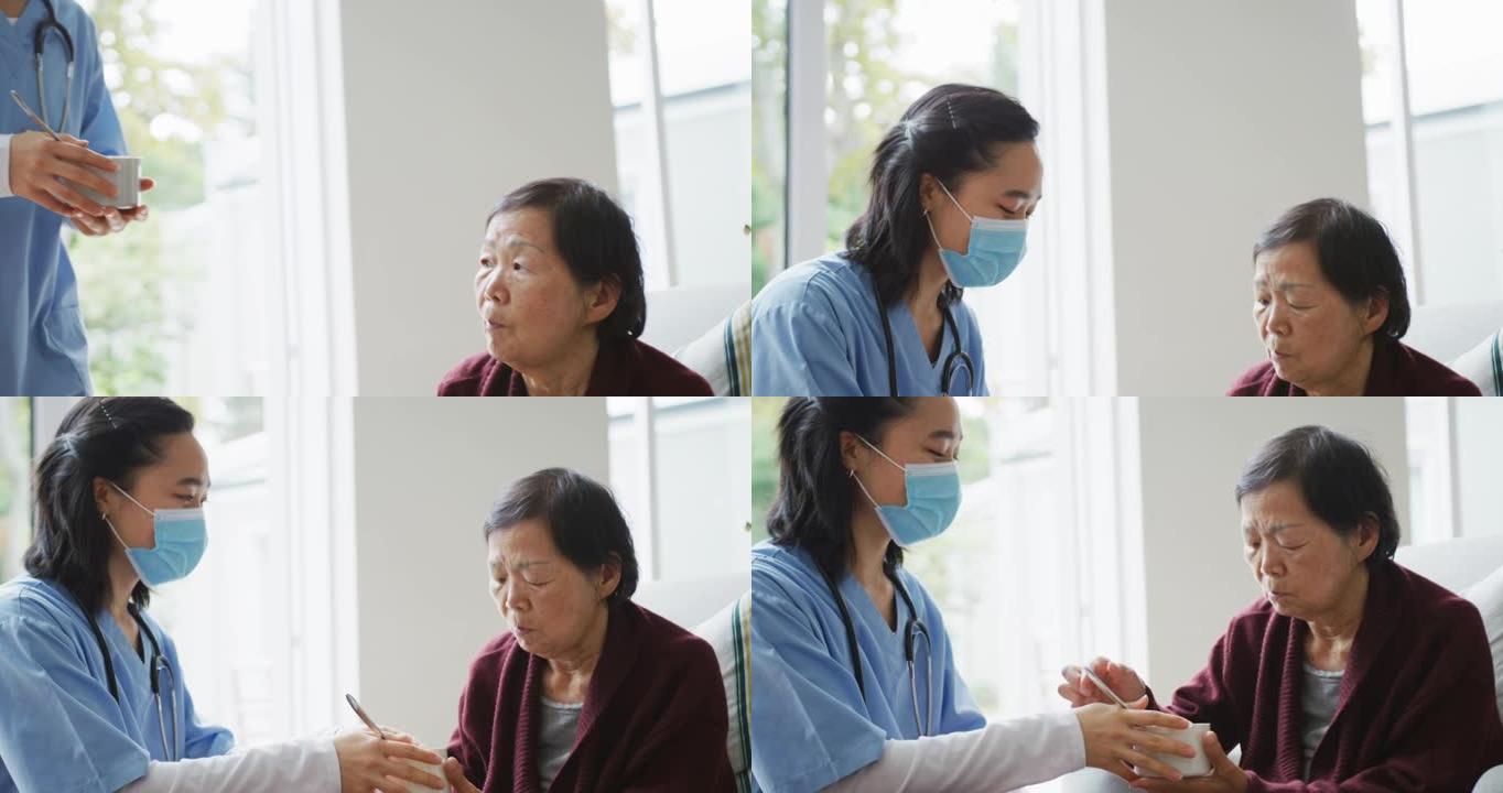 亚洲女护士戴口罩带汤给坐在病床上的资深女病人