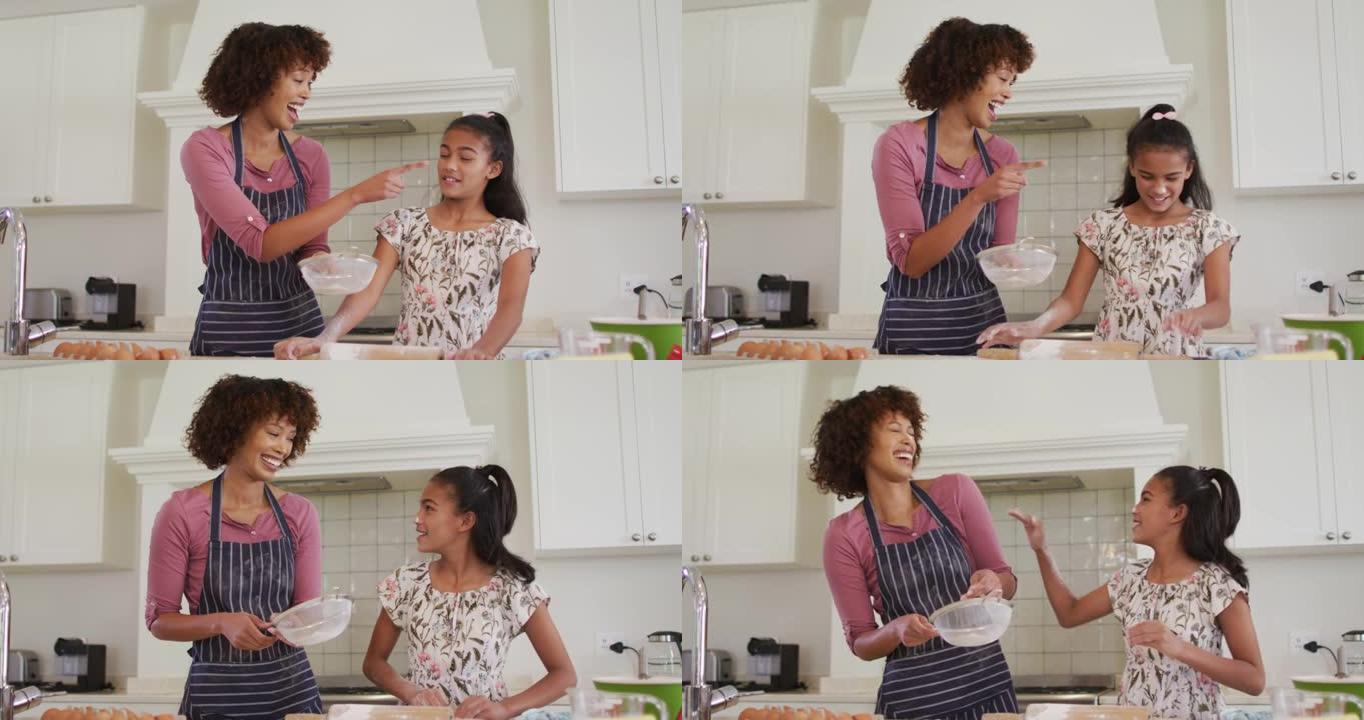 非裔美国母亲和女儿在家里的厨房里一起烘烤