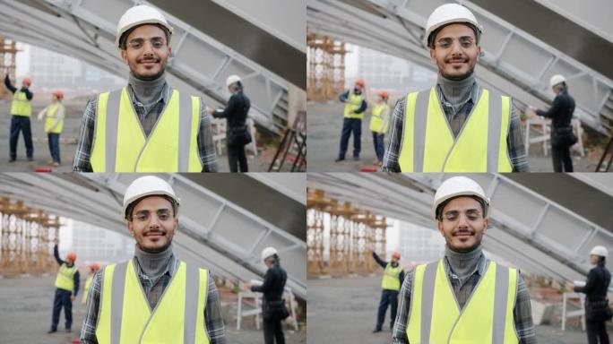 穿着制服站在建筑工地的年轻中东建筑商的慢动作肖像