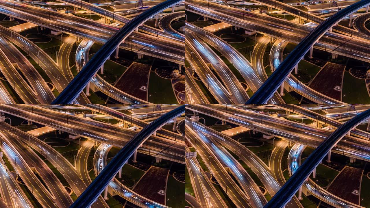 阿联酋迪拜夜间立交桥和城市交通的T/L盘鸟瞰图
