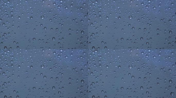 晚上玻璃上的雨滴背景