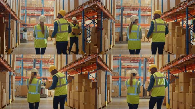 戴着安全帽的男女工人穿过零售仓库，里面装满了纸箱里的货物。在物流配送中心工作。慢动作拍摄后