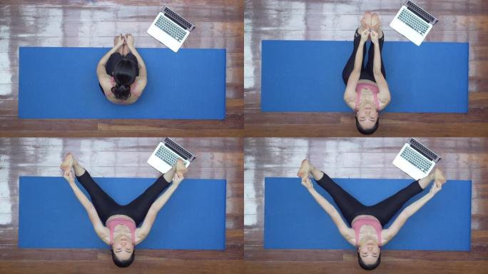 亚洲女性在家用笔记本电脑练习瑜伽的俯视图
