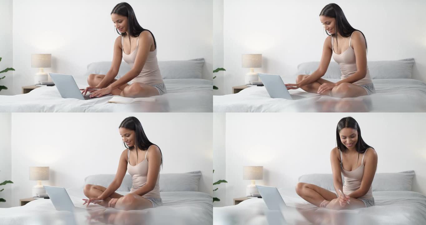 4k视频片段，一名年轻女子使用笔记本电脑并在家中床上做笔记