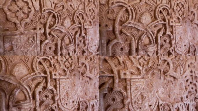 西班牙格拉纳达阿尔罕布拉宫建筑墙细节的万向节镜头。摄像机沿着装饰有摩尔装饰的墙壁移动