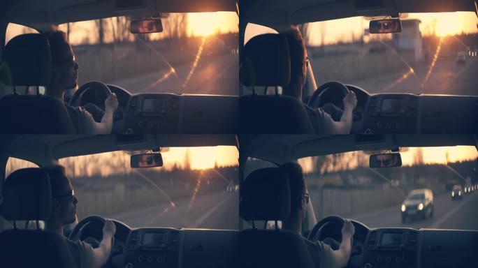 日落背景下的人开车。变形镜头拍摄