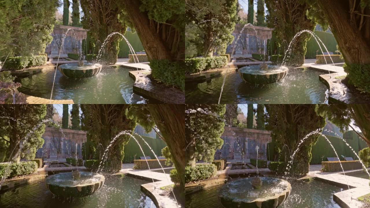 慢动作万向节拍摄的喷泉周围的树木在阿罕布拉的花园Generalife。格拉纳达,西班牙