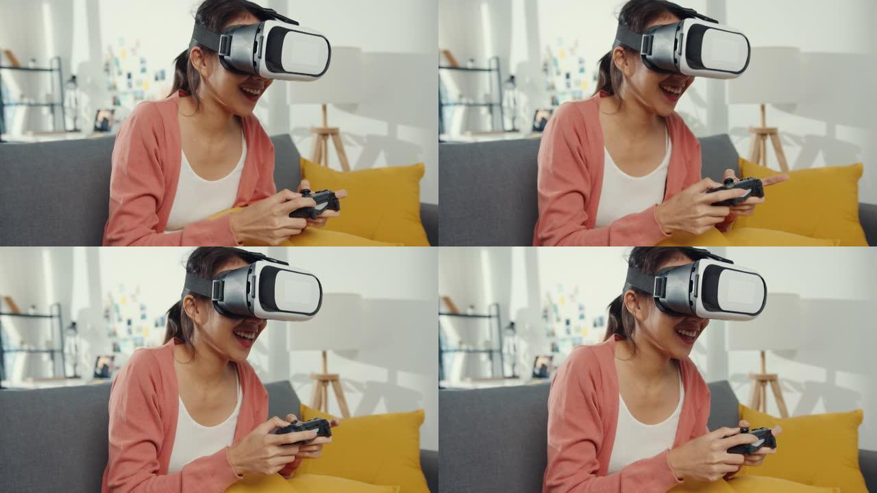 亚洲女士戴着虚拟现实的耳机眼镜在客厅的沙发上玩操纵杆游戏。