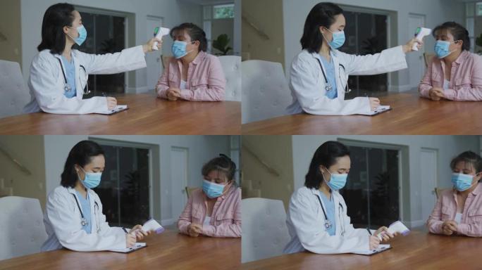 亚洲女护士戴口罩住院女病人体温