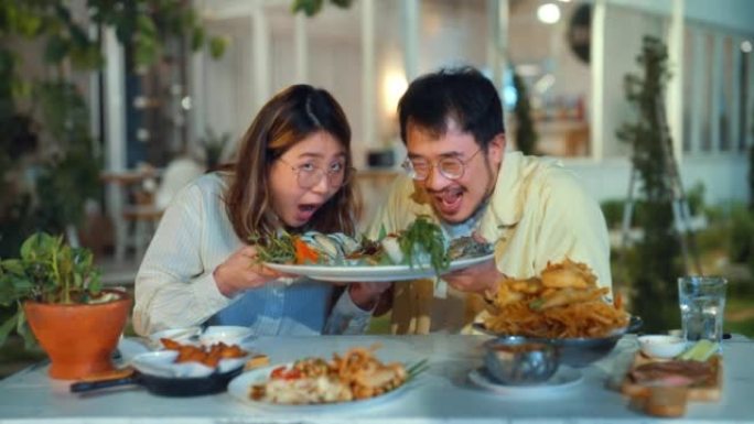 夫妇在餐厅享用亚洲美食晚餐。