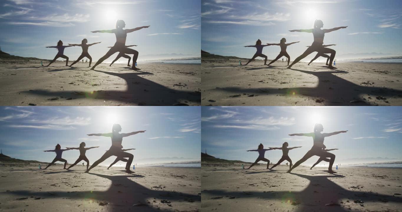 一群在海滩上练习瑜伽的女性朋友