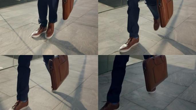一个男人的脚穿着棕色鞋子，在铺好的街道上行走的视频，高角度视图