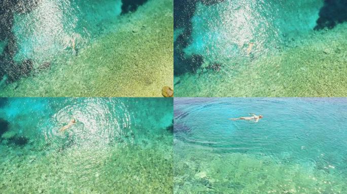 空中女人在亚得里亚海的绿松石水中放松