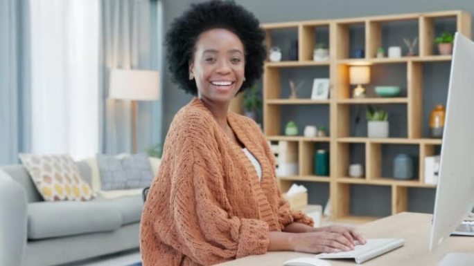 成功的女企业家研究创业公司的新思路和营销策略。一名非裔美国妇女在家庭办公室做自由职业时使用桌面的肖像