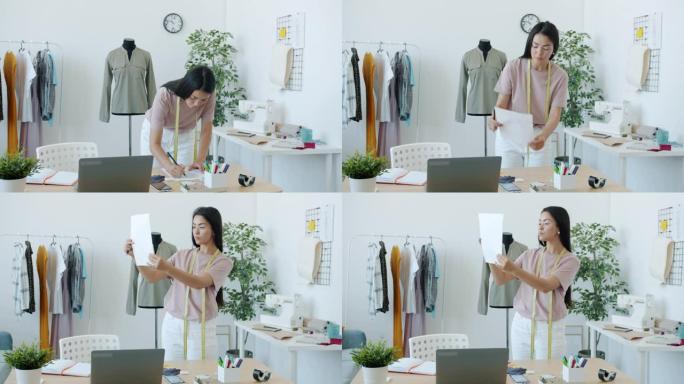 漂亮的亚洲女孩时装设计师正在纸上绘制时尚服装，在工作室中创建专注于创意活动的新服装系列