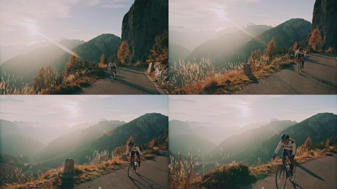骑自行车的人在阳光明媚的风景山中骑自行车上坡
