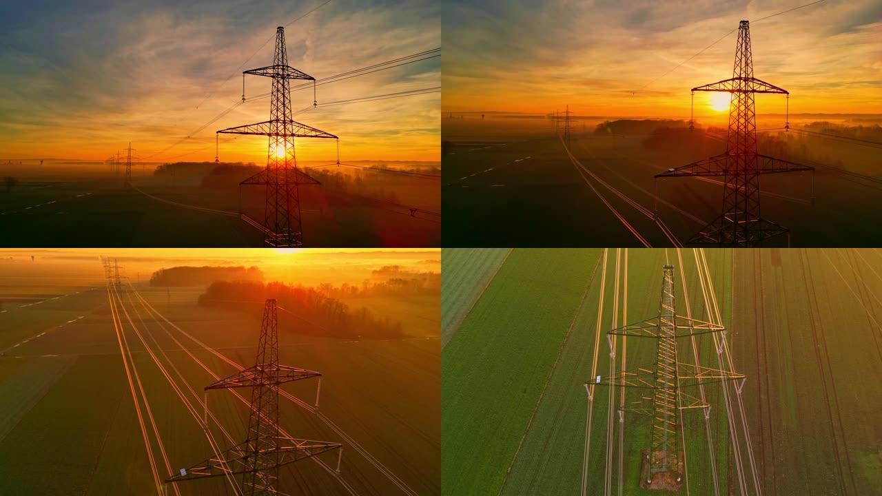 电力塔和电力线路对抗农村戏剧性的日落天空