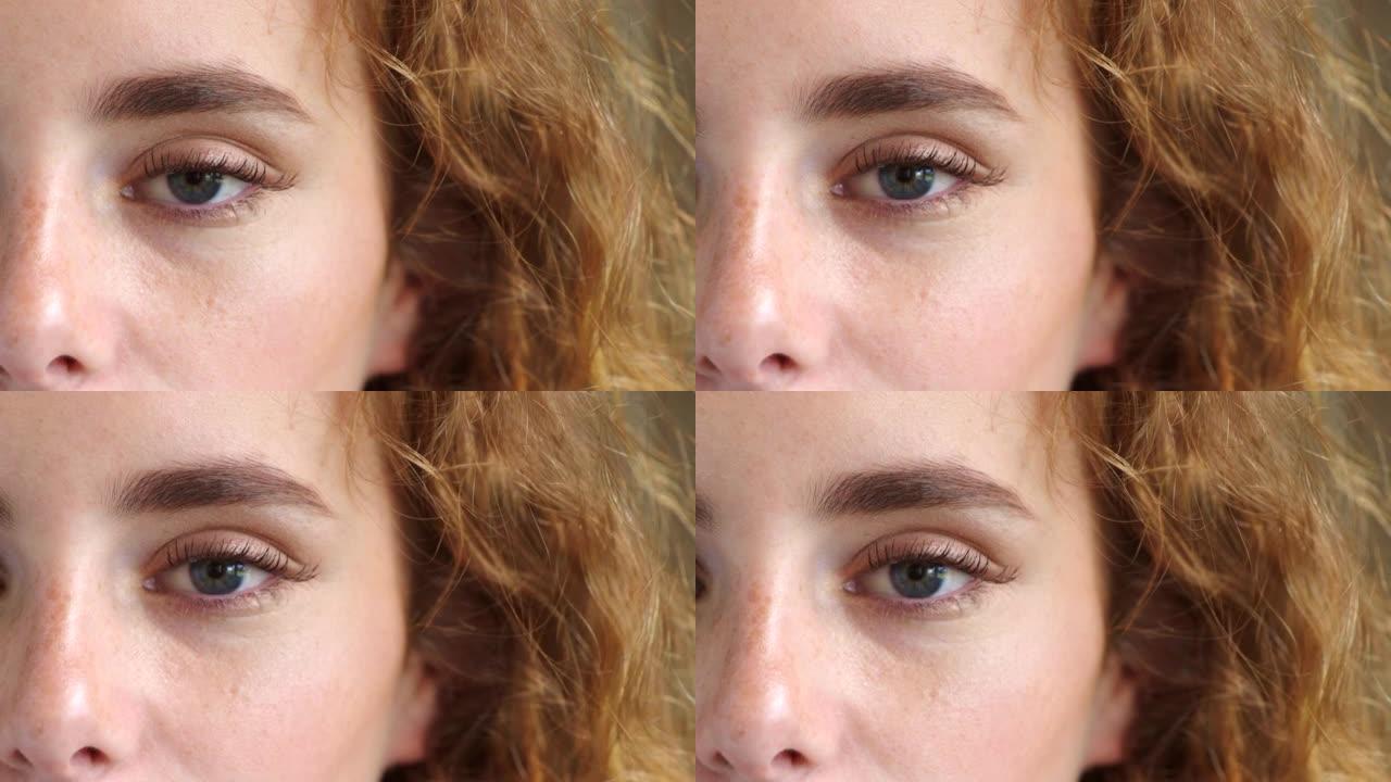 一个女人在验光师测试视力和视力的特写镜头。红色头发和雀斑的女性在用蓝眼睛凝视着相机时眨眼。带着灵感的