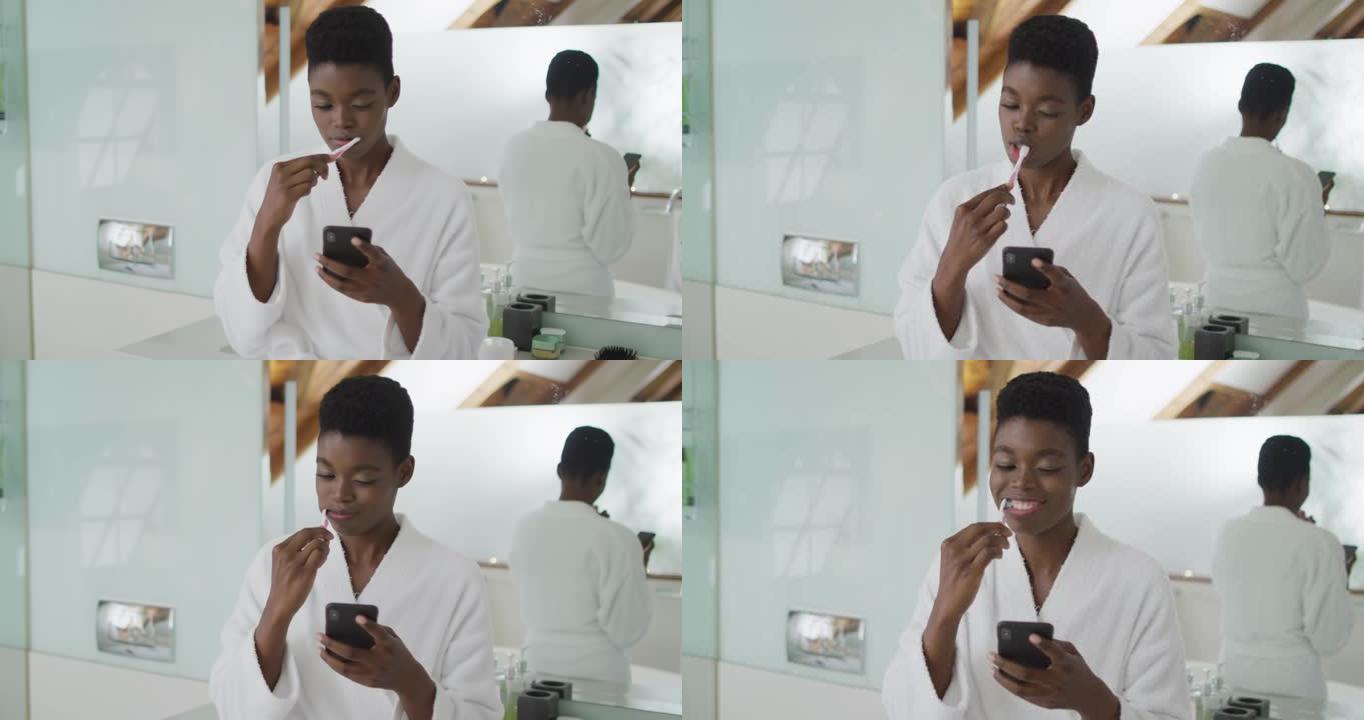 非裔美国有吸引力的女人在浴室刷牙和使用智能手机