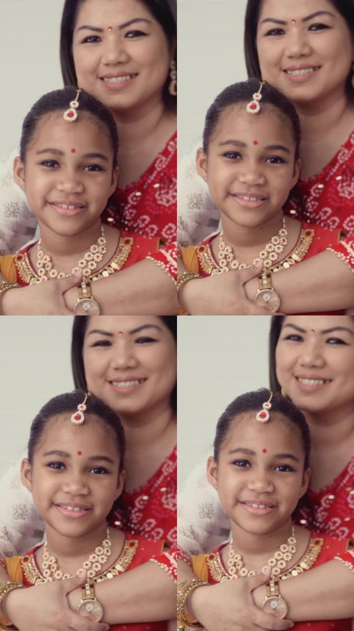 亚洲的印度文化母亲亲吻女儿外国人笑脸笑容