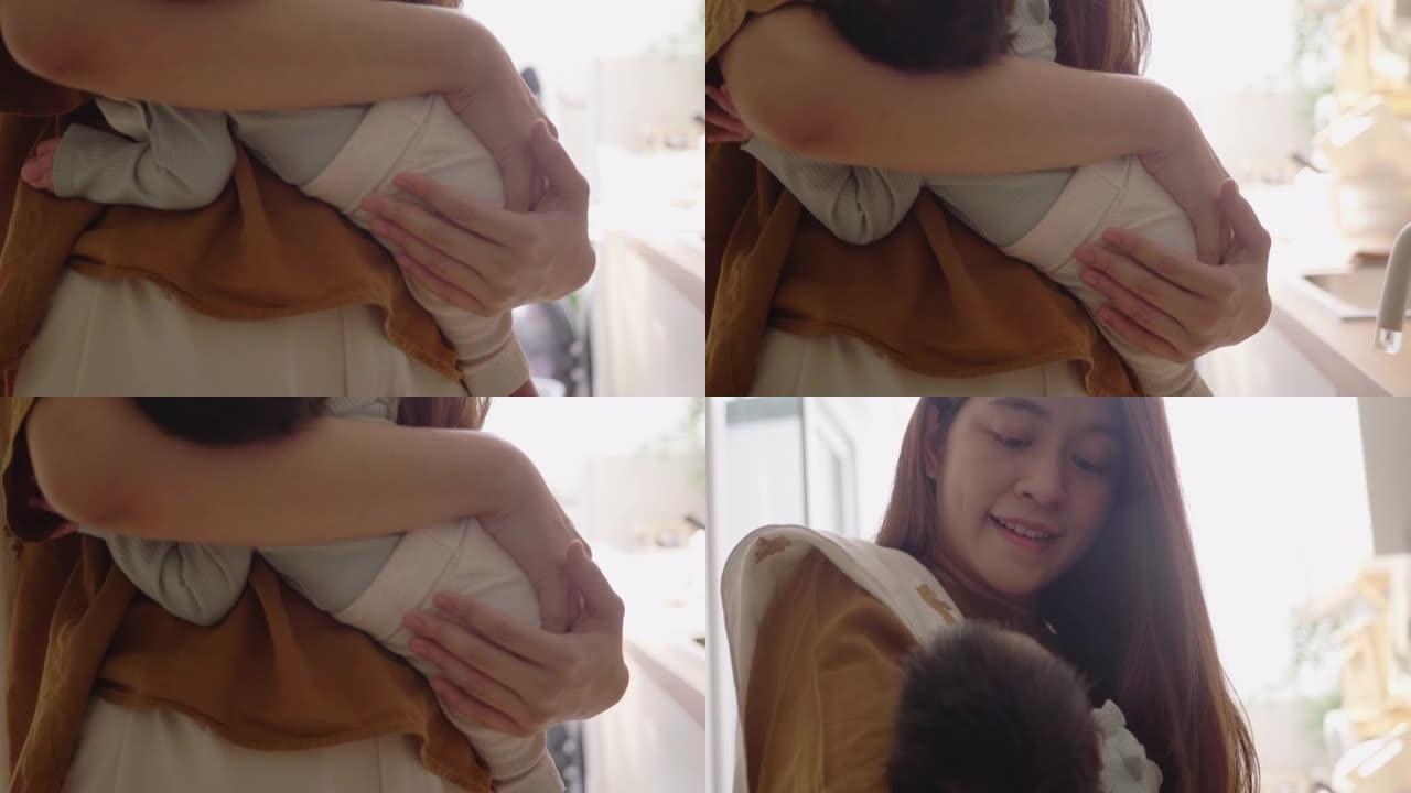 亚洲妈妈抱着她可爱的宝宝。