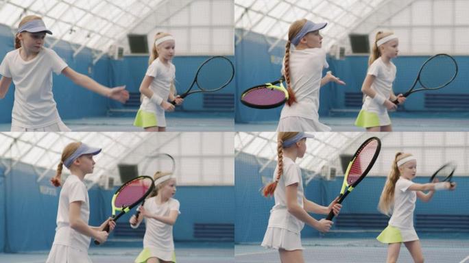 年轻女孩在球场上练习网球