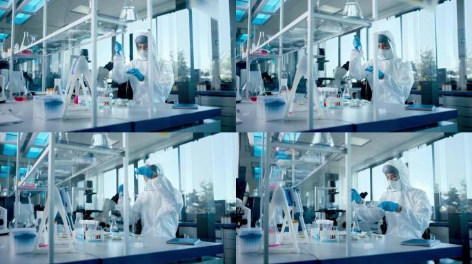 美丽的女医学家穿着工作服和面罩，使用微量移液器，同时使用试管。疫苗、药物研发创新实验室、现代化设备