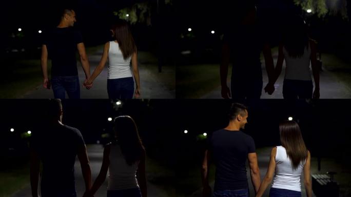在夜公园散步的年轻夫妇