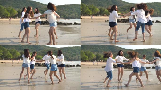一群朋友在日落时带着快乐的情感在沙滩上跳舞: 露营，旅行和友谊的概念