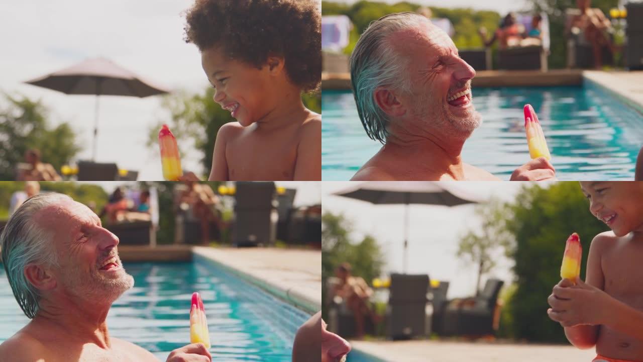祖父和孙子在家庭暑假在游泳池边缘吃冰棍