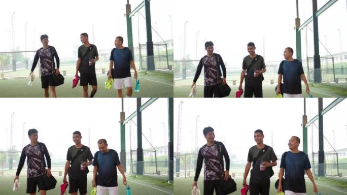 亚洲男子足球运动员穿越田野