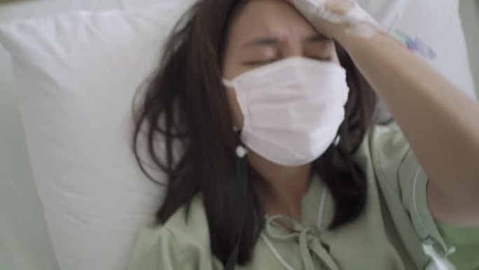 亚洲女性患者的手持镜头在医院病房头痛