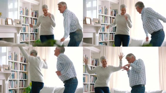 精力充沛，快乐的老夫妇一起在家里跳舞，享受退休生活。音乐，舞蹈和高级夫妇在客厅，庆祝退休生活。祖父母