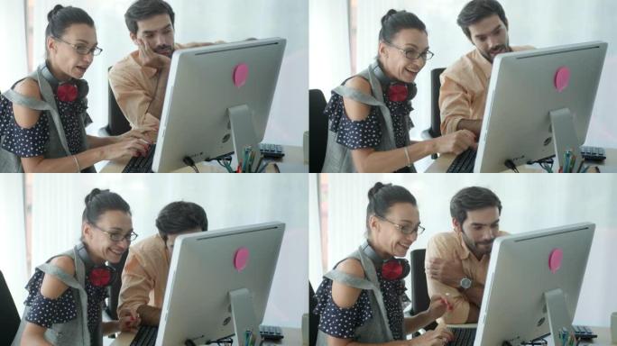 两个同事使用计算机并在现代办公室中讨论慢动作