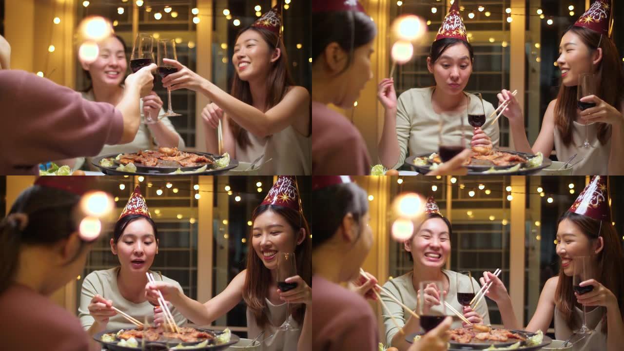 派对烧烤晚餐，一群亚洲女性用酒杯享受派对之夜