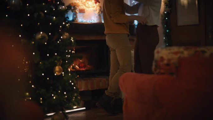 在圣诞节期间，SLO MO DS无法识别的夫妇在壁炉前拥抱
